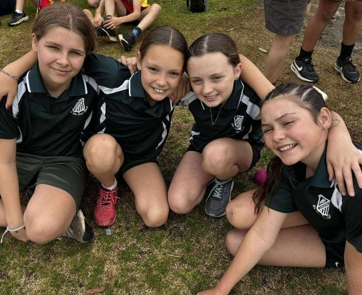 4 senior girls posing for the photo at athletics