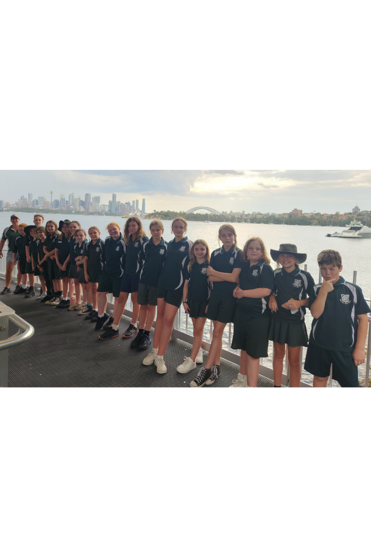 Year 3-6 students in Syneys posing in front of the Sydney Harbour Bridge