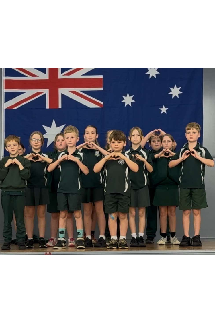 Signing choir performing in front of Australian flag